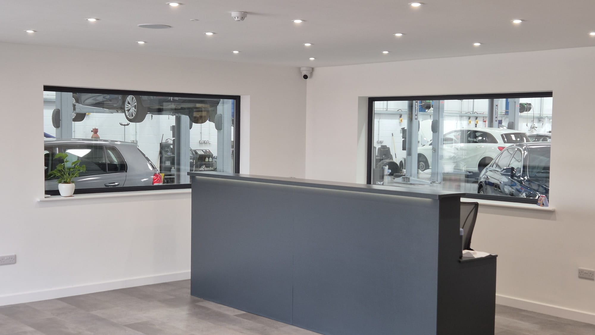 The reception desk with windows looking onto the workshop